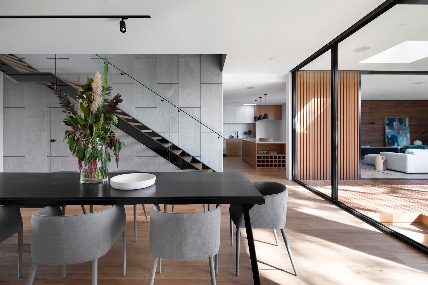 Stone and timber courtyard house seen through glass